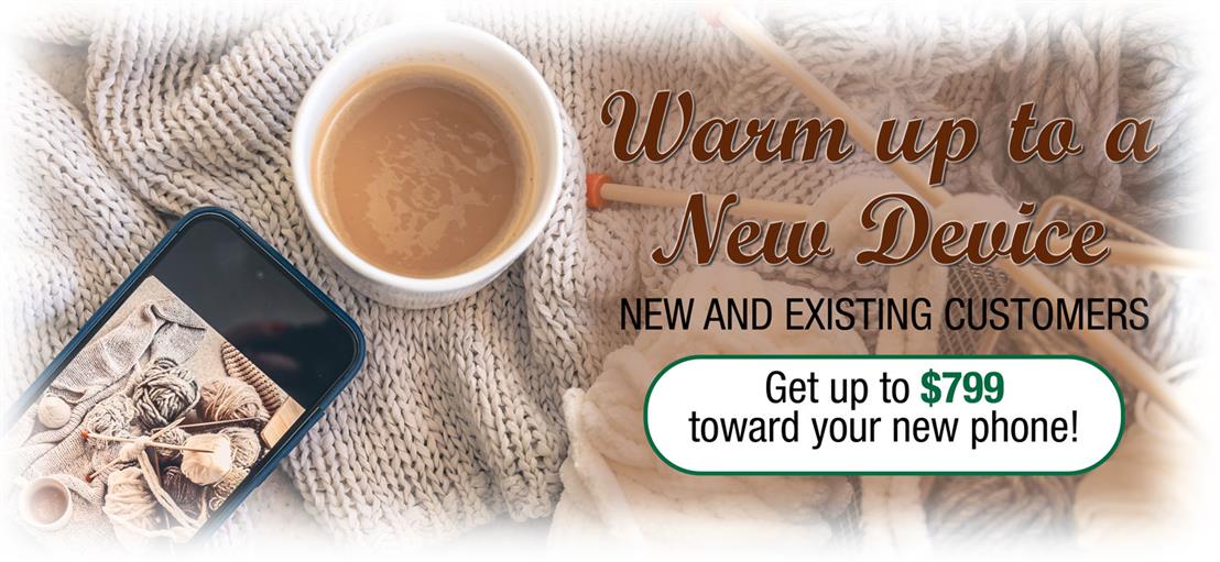 Image of coffee, a cell phone, and knitting needles on a quilt.